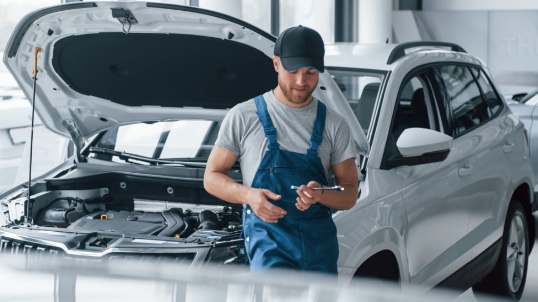resting-workplace-employee-blue-colored-uniform-stands-automobile-salon (1)
